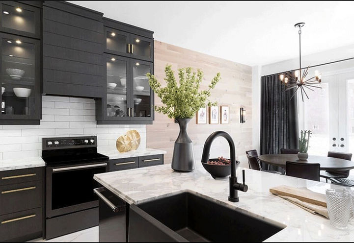 Evoke Modern Towns Kitchen with Black Cupboards and Appliances